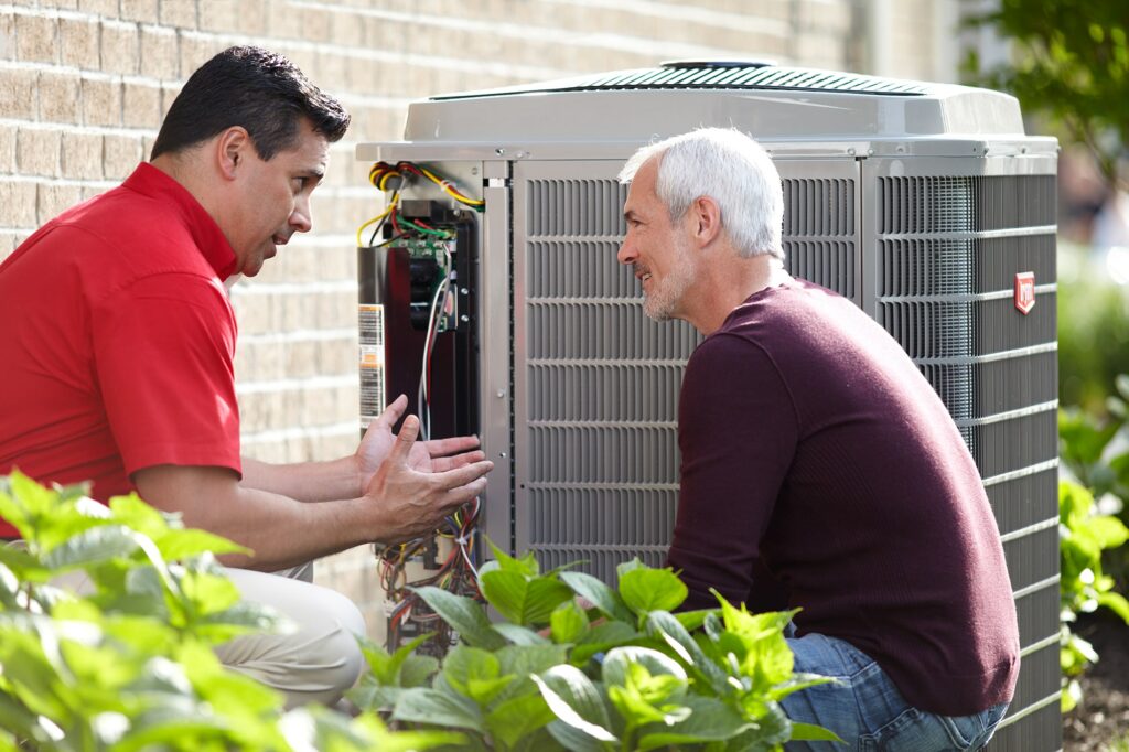 Bryant tech with customer at air conditioner