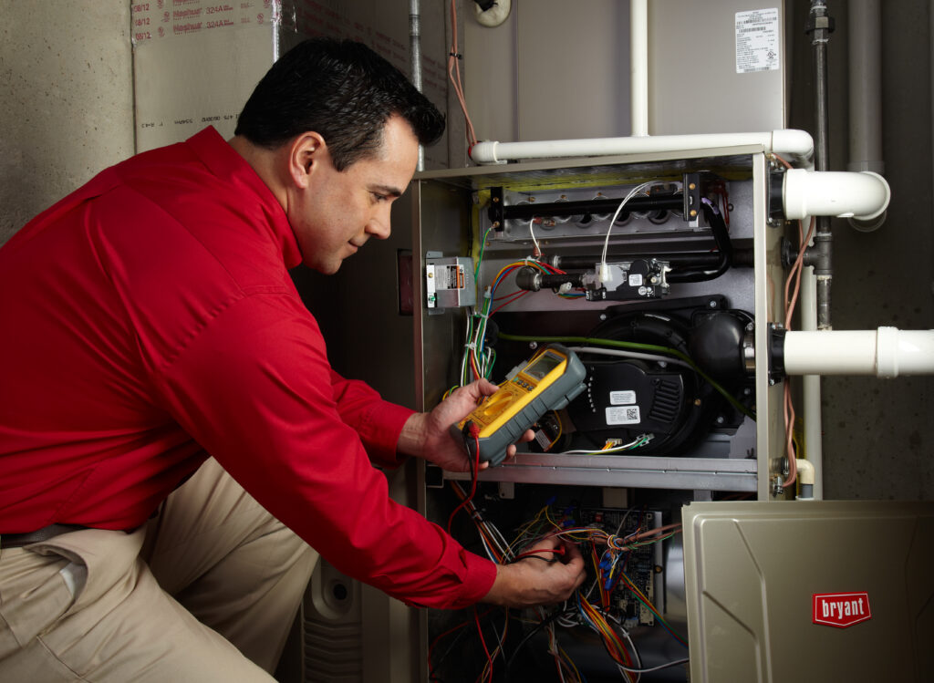 Bryant Technician working during furnace inspection