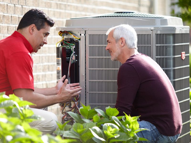 Bryant tech with customer at air conditioner